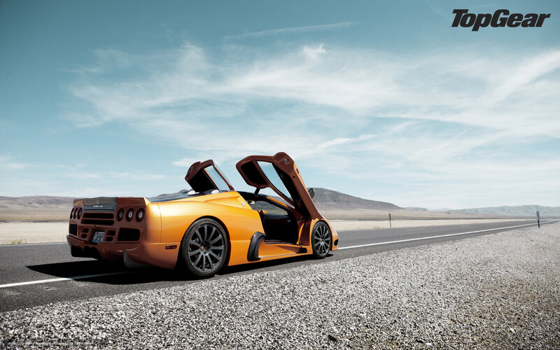 Orange sports car on desert road