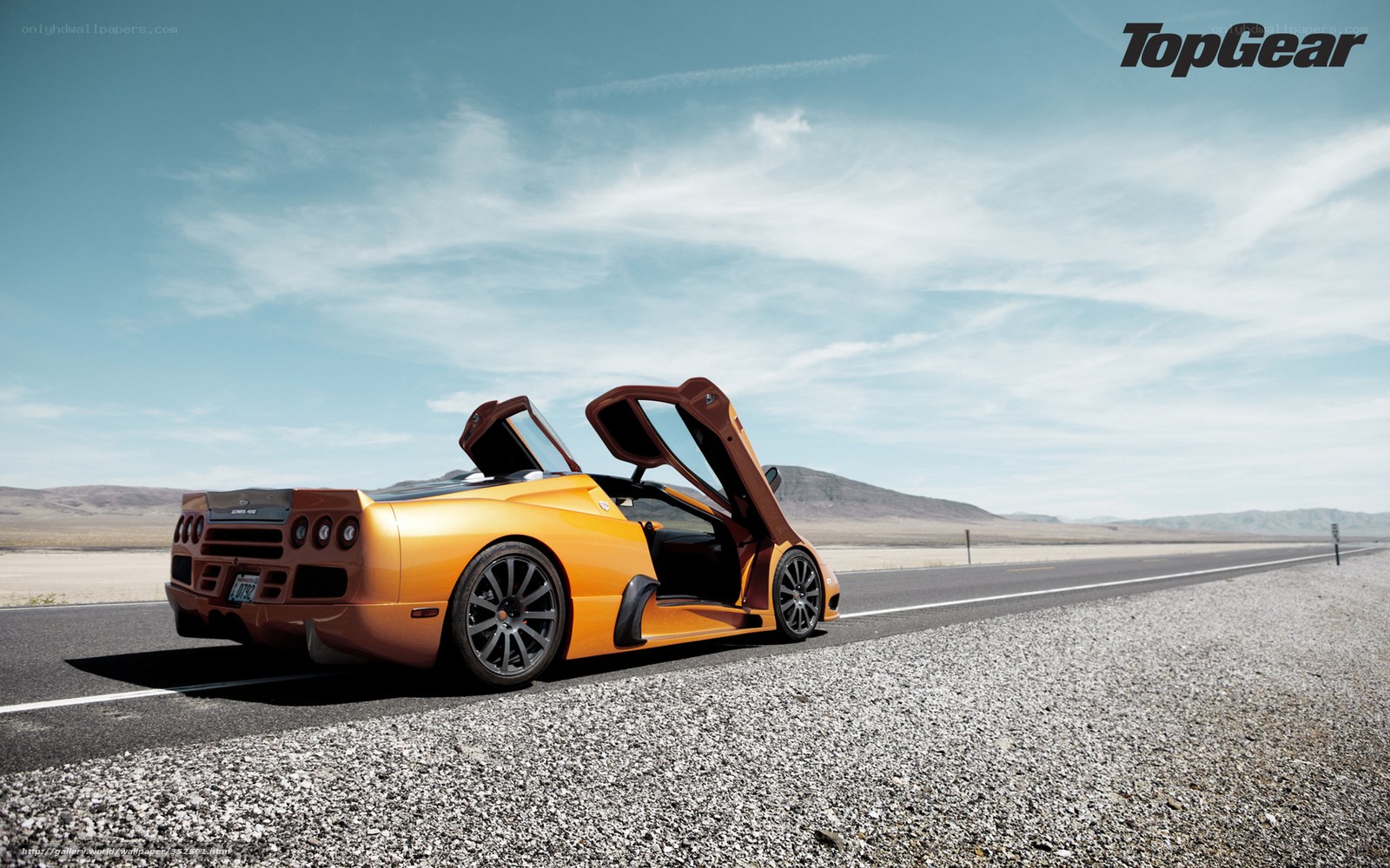 Orange sports car on desert road