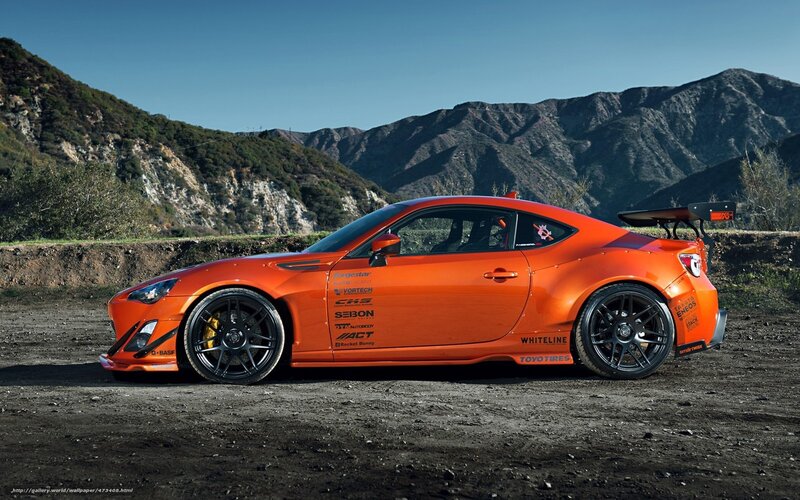orange sports car on dirt road