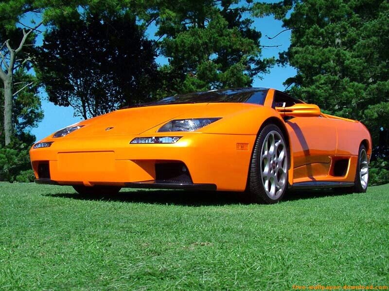 orange sports car on grass