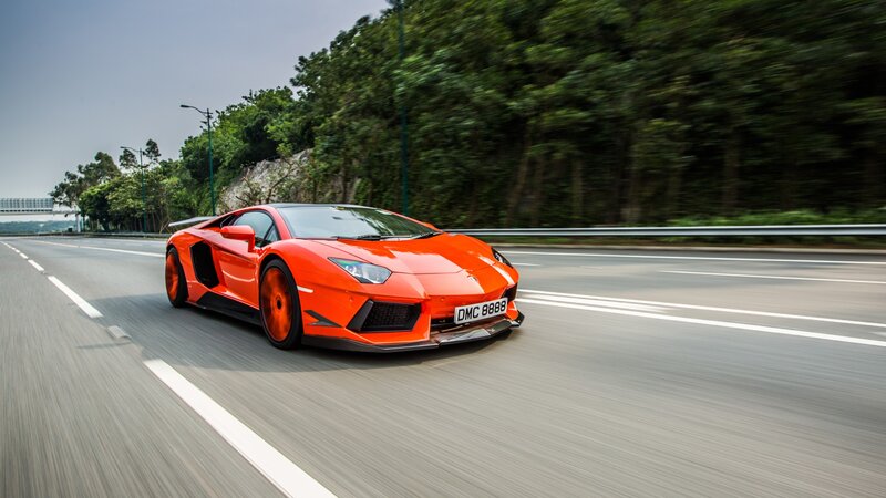 orange sports car on highway