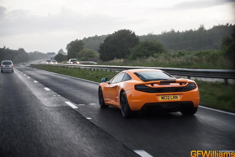 orange sports car on highway
