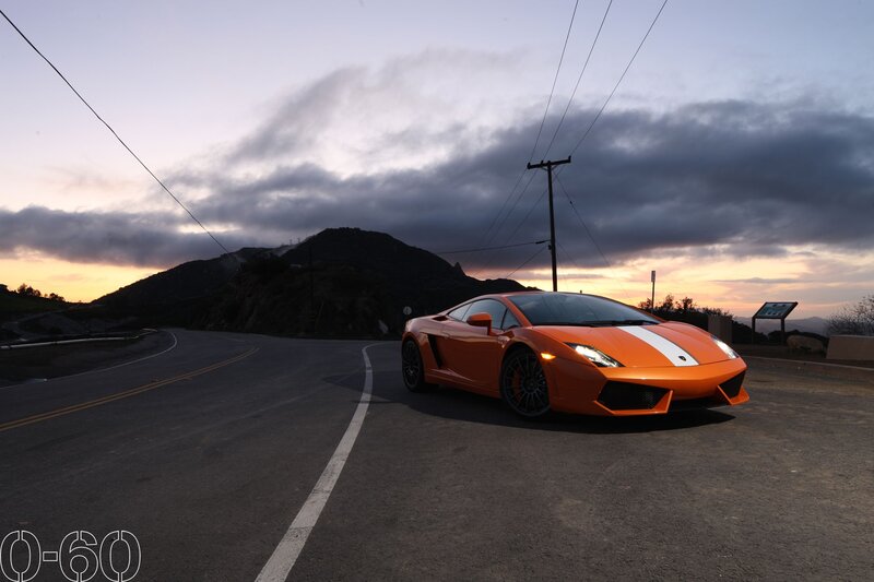 Orange sports car on mountain road
