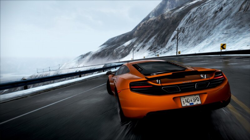 orange sports car on mountain road