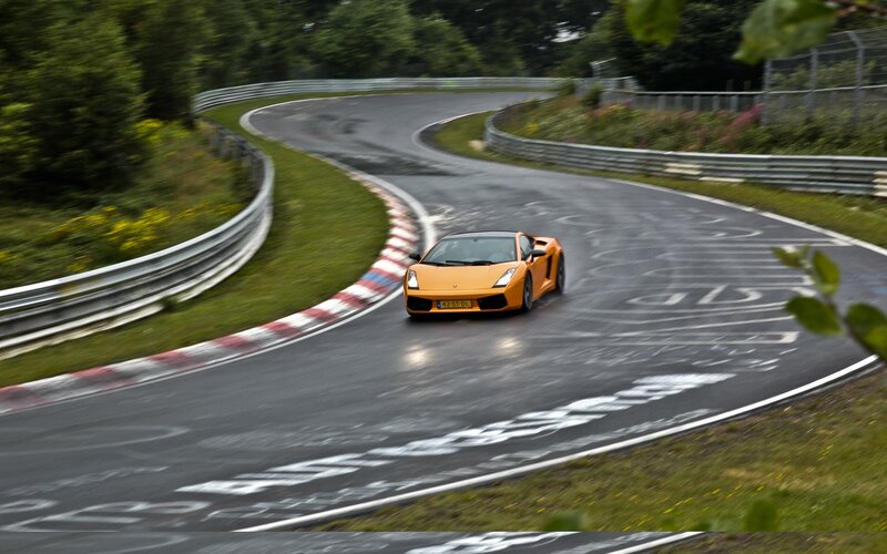 orange sports car on racetrack