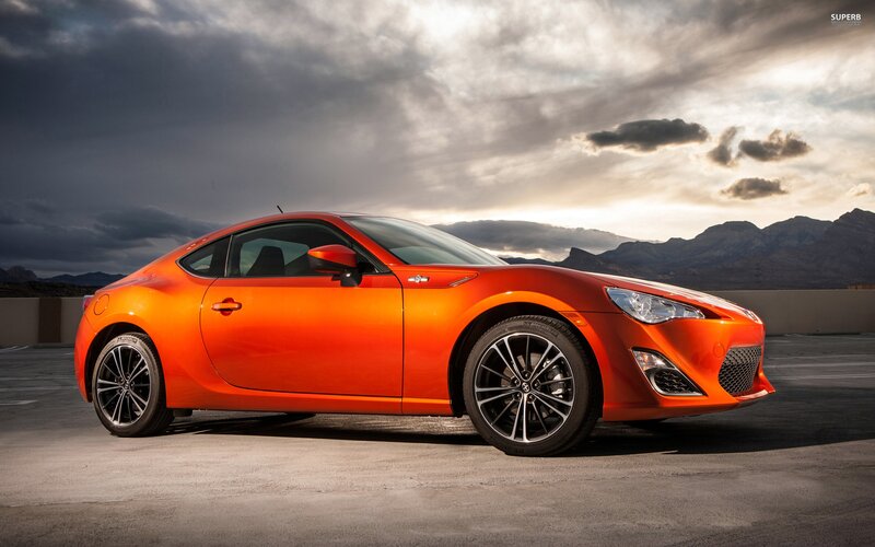 orange sports car on rooftop