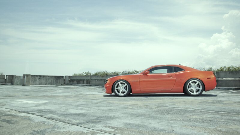 orange sports car on rooftop