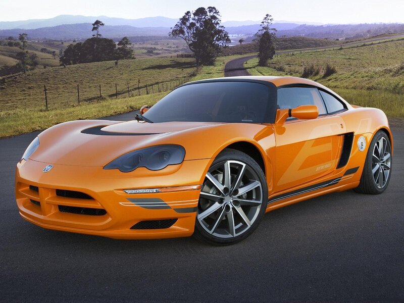 orange sports car on rural road