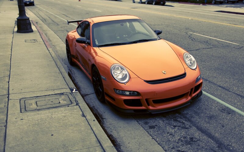 orange sports car on street