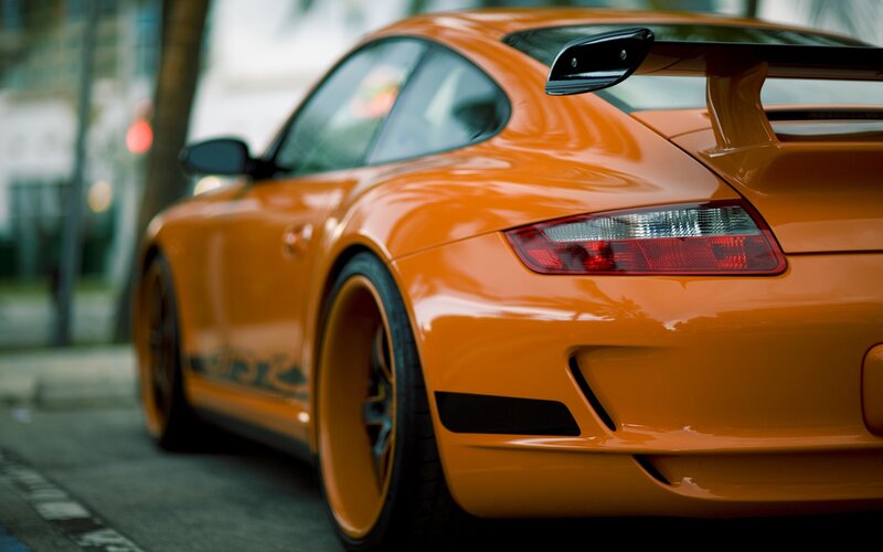 orange sports car on street