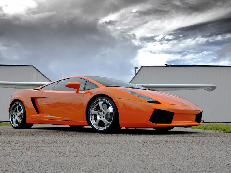 orange sports car on tarmac