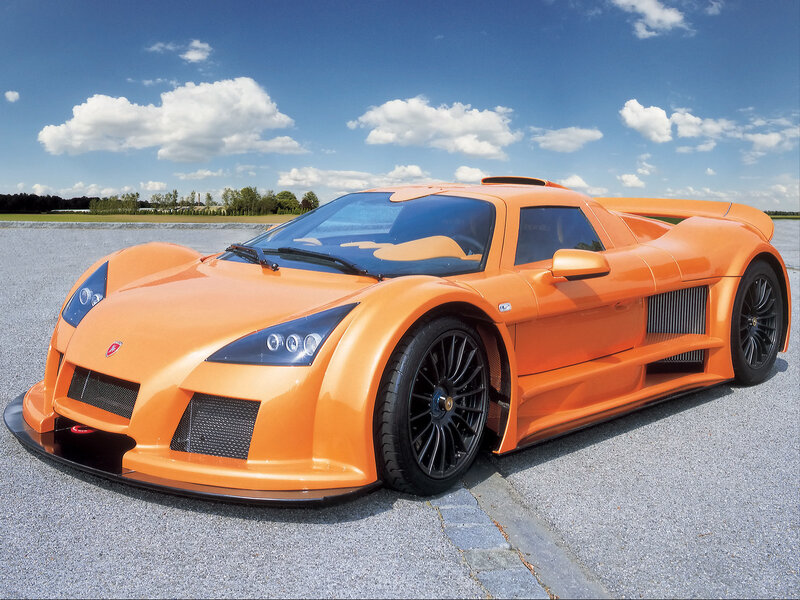 orange sports car on tarmac