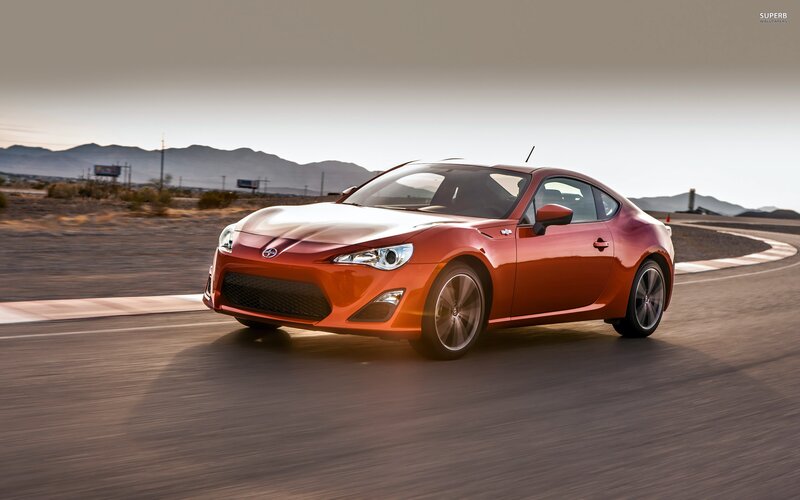 orange sports car on track