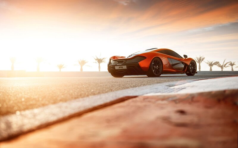 Orange sports car on track at sunset