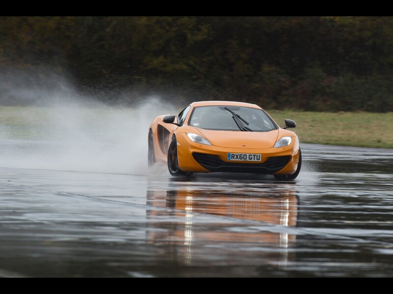 Orange sports car on wet track