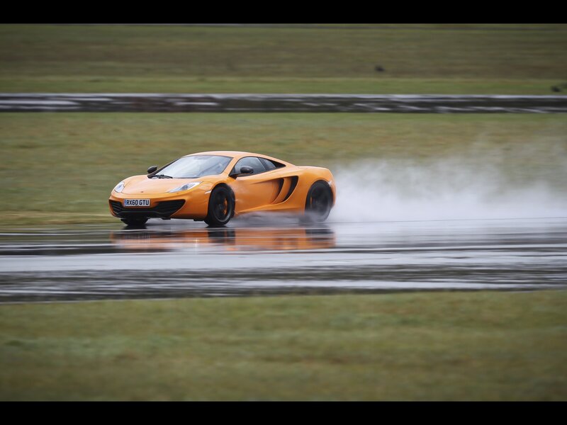 Orange sports car on wet track