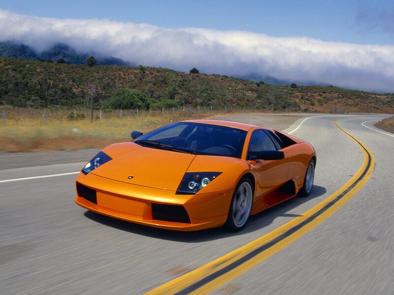orange sports car on winding road