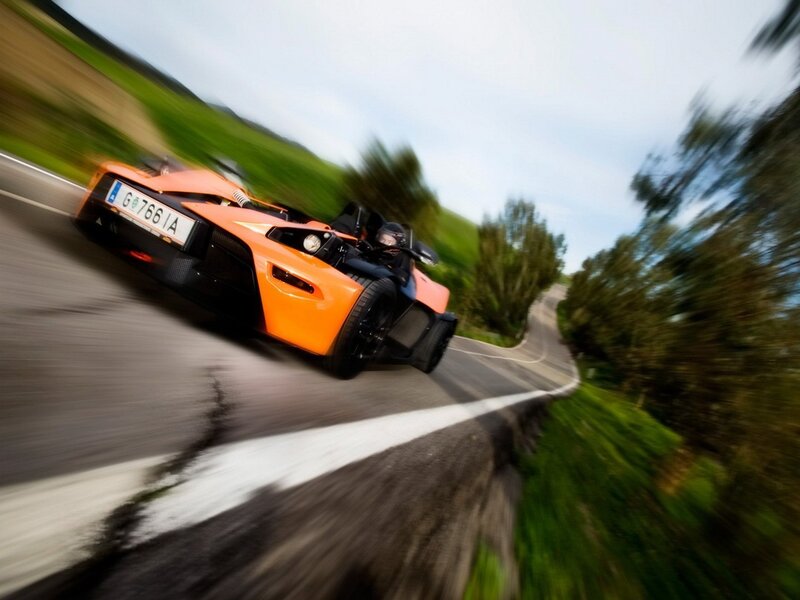 Orange sports car on winding road