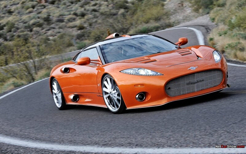 orange sports car on winding road