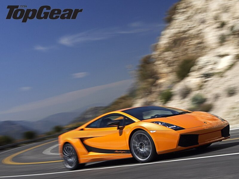 orange sports car on winding road