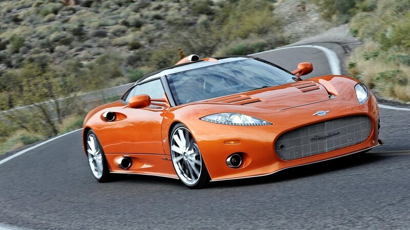 orange sports car on winding road