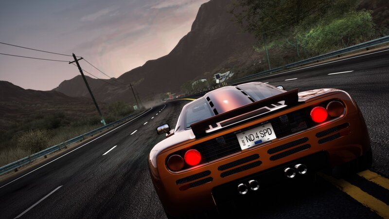 orange sports car on winding road