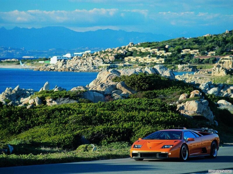 Orange Sports Car — Serene, Afternoon, Photograph, Coastline