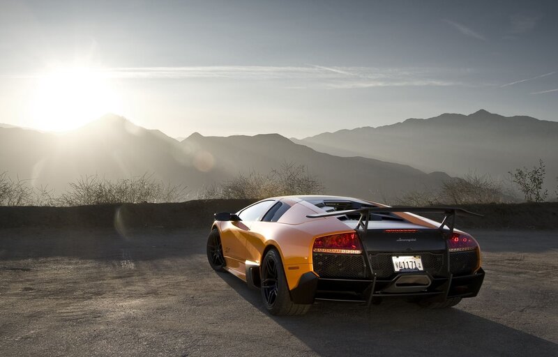 Orange Sports Car — Serene, Sunset, Photograph, Mountains