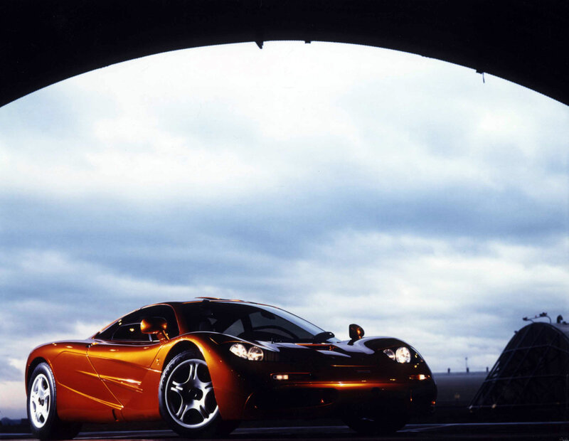 orange sports car under bridge
