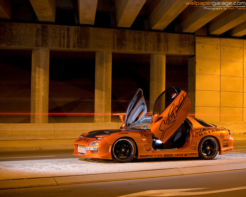 orange sports car under bridge