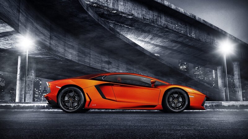 Orange sports car under bridge