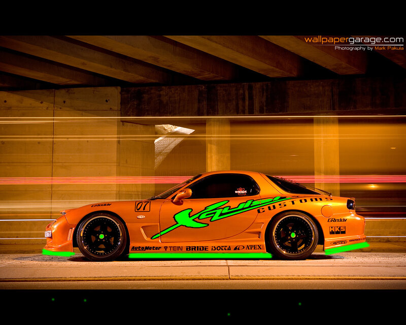 orange sports car under bridge