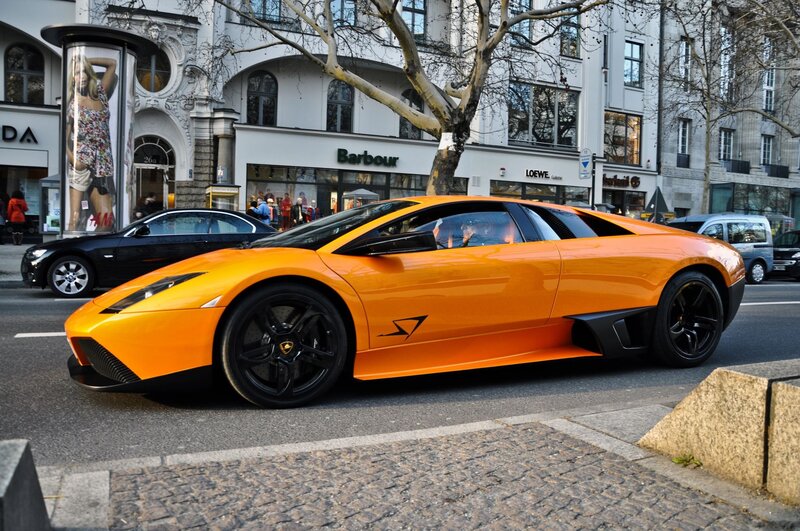 Orange Sports Car — Urban, Afternoon, Photograph, Black Sedan