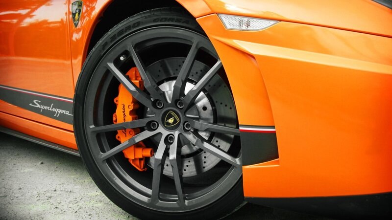 Orange Sports Car Wheel — Dramatic, Photograph
