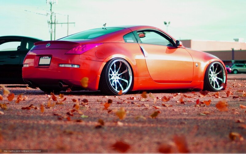 orange sports car with autumn leaves