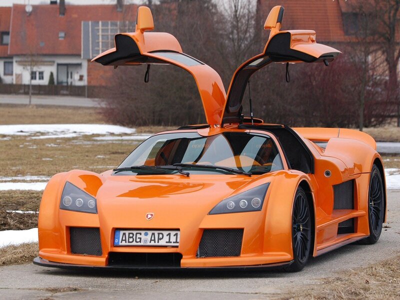 orange sports car with doors open