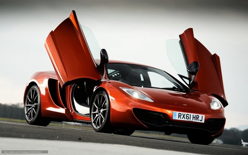 orange sports car with doors open