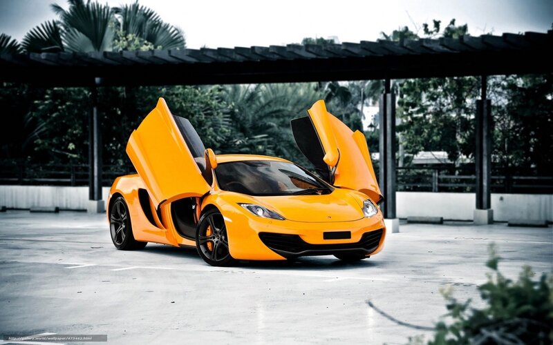 orange sports car with doors open