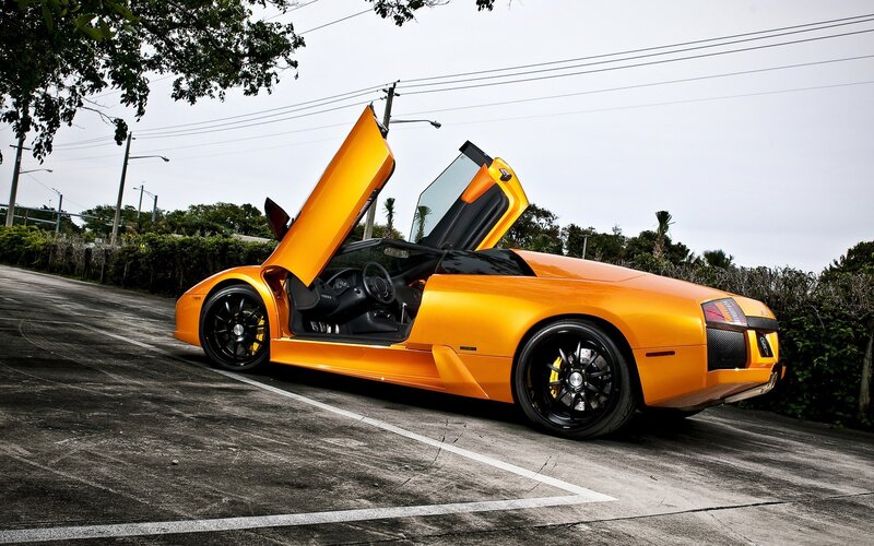 orange sports car with doors open