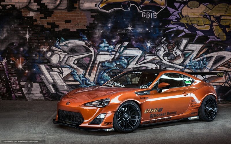 Orange sports car with graffiti