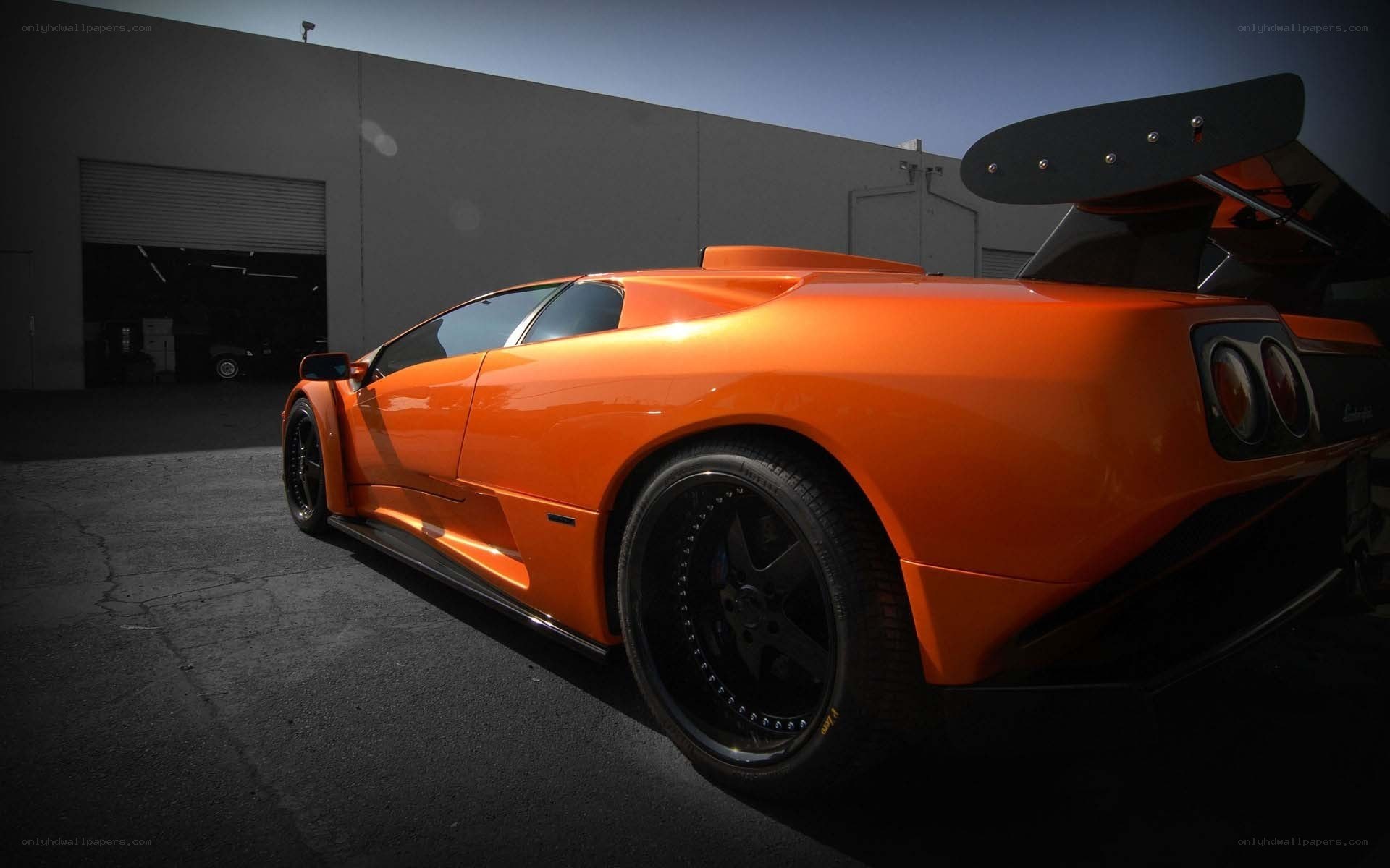 orange sports car with large wing
