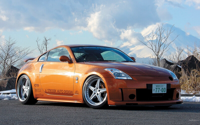 Orange sports car with Mount Fuji