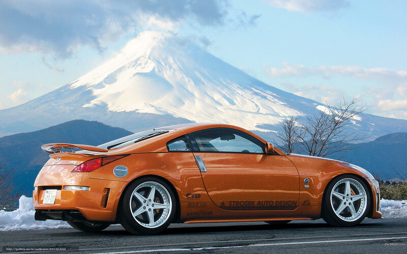 Orange sports car with Mount Fuji