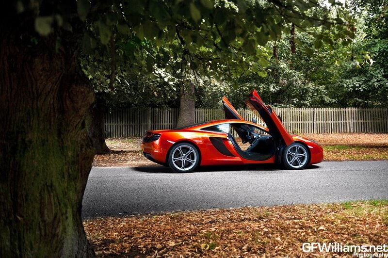Orange sports car with open doors