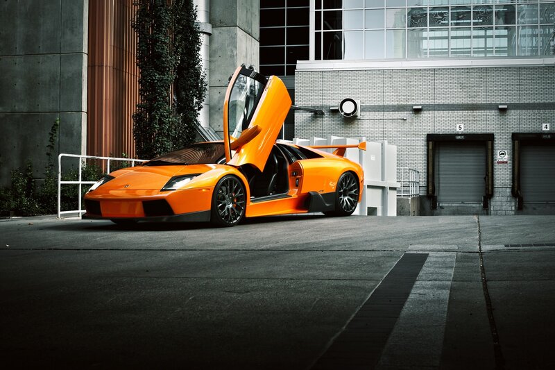 orange sports car with open doors