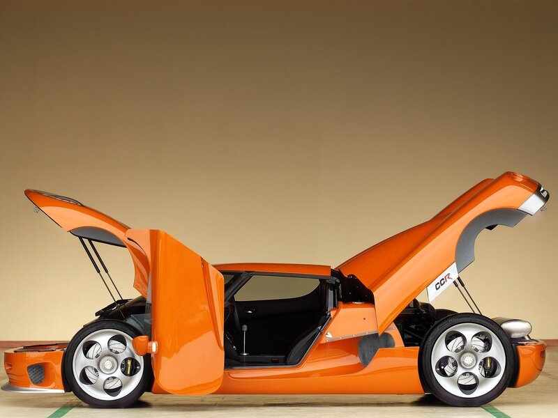 Orange sports car with open doors