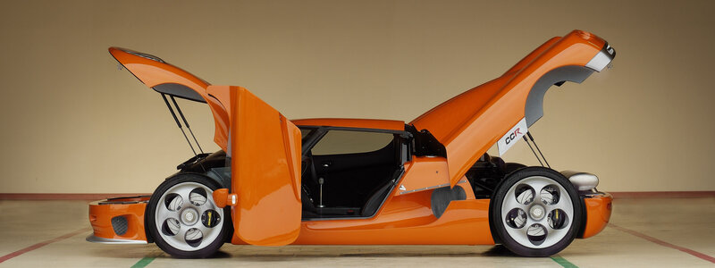 orange sports car with open doors