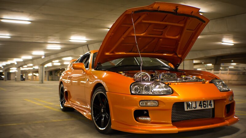 Orange sports car with open hood