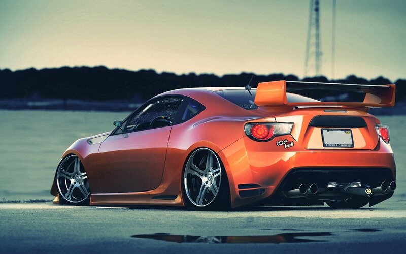 orange sports car with spoiler