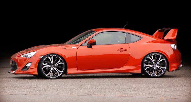 orange sports car with spoiler